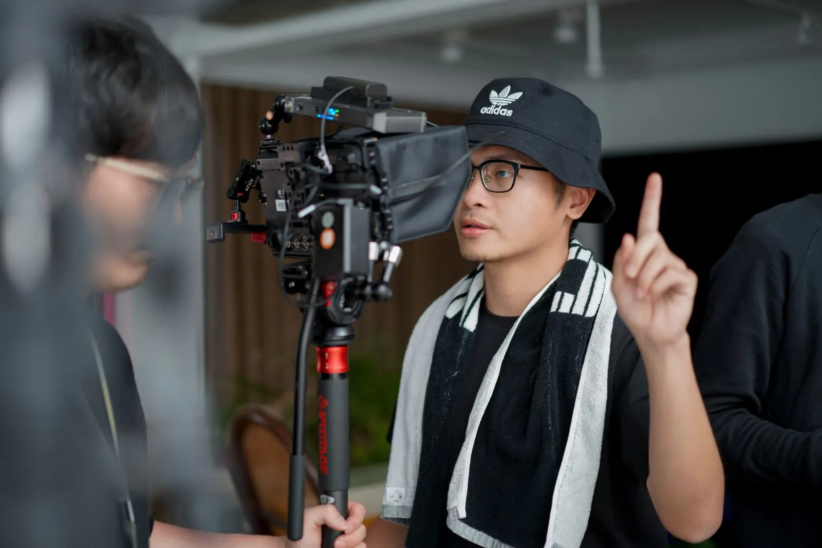 Director manejando el equipo de filmación junto al equipo técnico