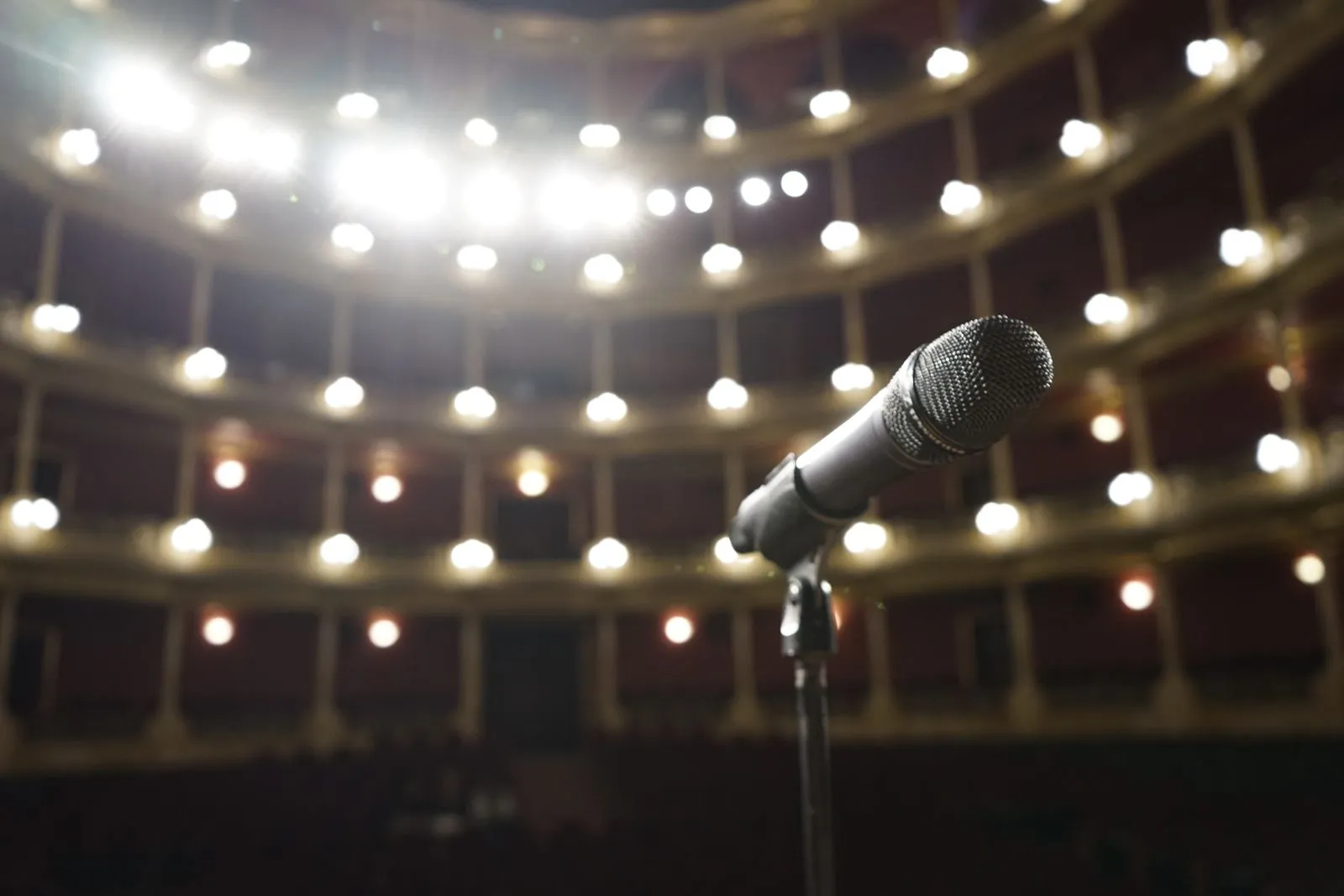 Micrófono en un escenario con luces de teatro